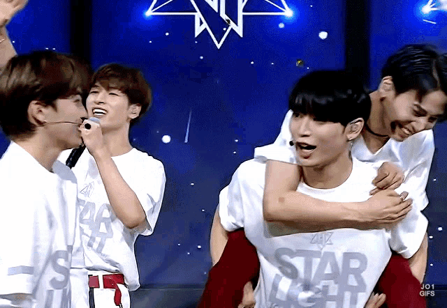 a man wearing a shirt that says starlight is being carried by two other men