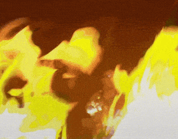 a close up of a person 's face with flames coming out of their mouth