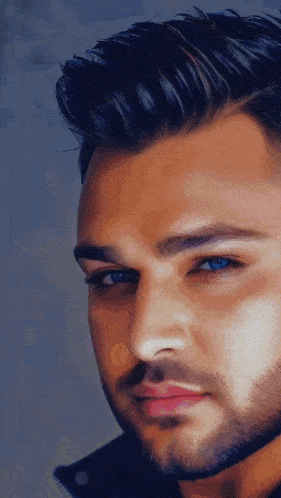 a close up of a man with a beard and blue eyes