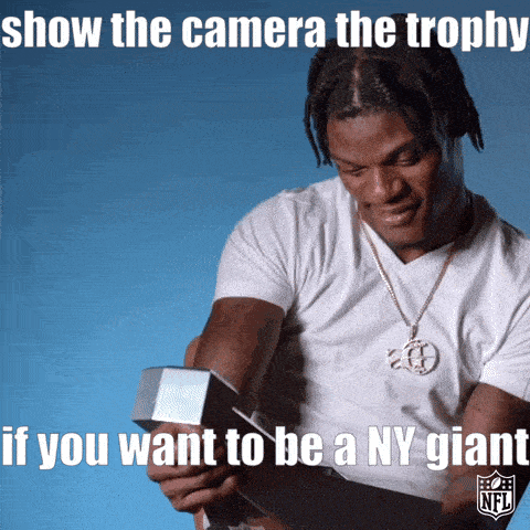 a man holding a trophy with the caption show the camera the trophy if you want to be a ny giants