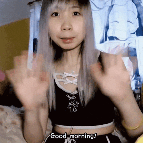 a girl says " good morning " with her hands in the air