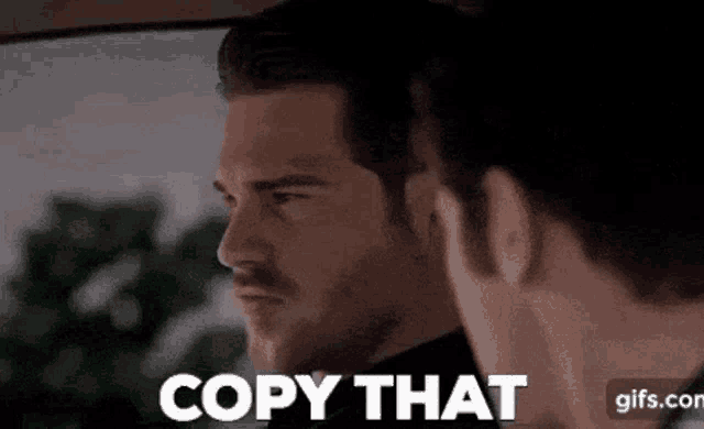 a man is talking to another man in a car and the man is saying copy that .