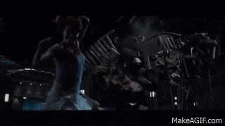 a t-rex is eating a dinosaur in a dark room .