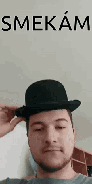 a man with a beard wearing a black bowler hat .