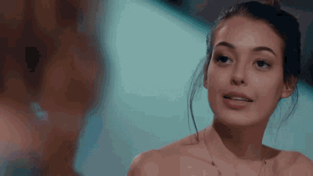 a woman is looking at herself in the mirror and smiling