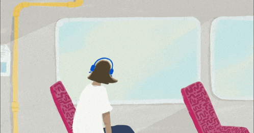 a woman wearing headphones looks out a window while sitting on a train