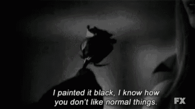 a black and white photo of a person holding a black rose and a quote .