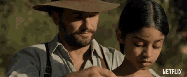 a man and a girl are standing next to each other with a netflix logo on the bottom