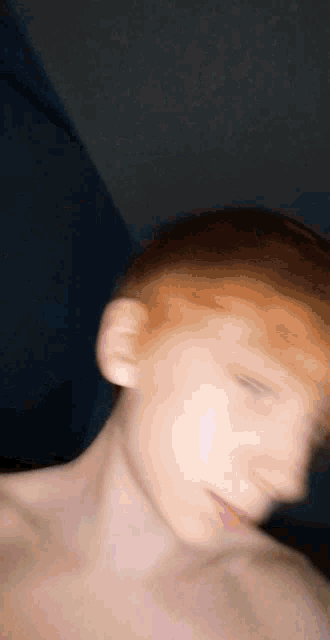 a close up of a person 's face with red hair