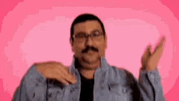 a man with glasses and a mustache is making a funny face .