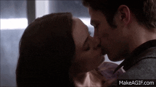 a man and a woman kissing on make a gif
