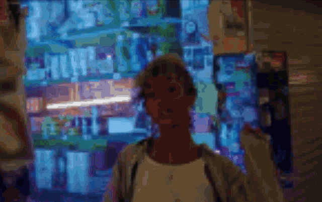 a blurred image of a person standing in front of a vending machine