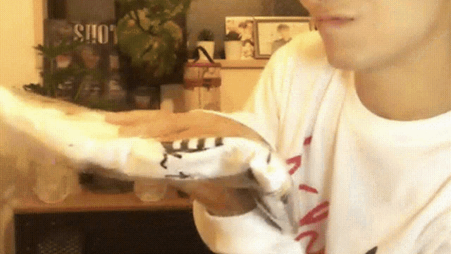 a person wearing a white shirt with the word louis on the front