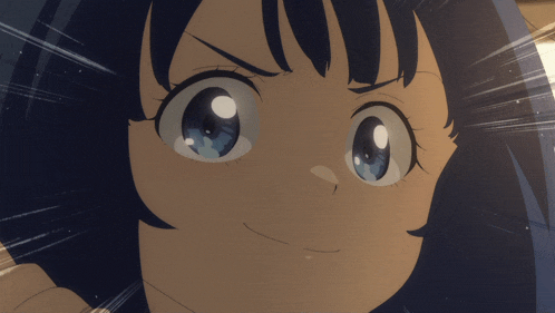 a close up of a girl 's face with big blue eyes