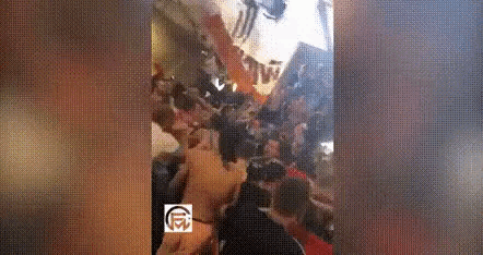 a group of people are standing in a line in a store .