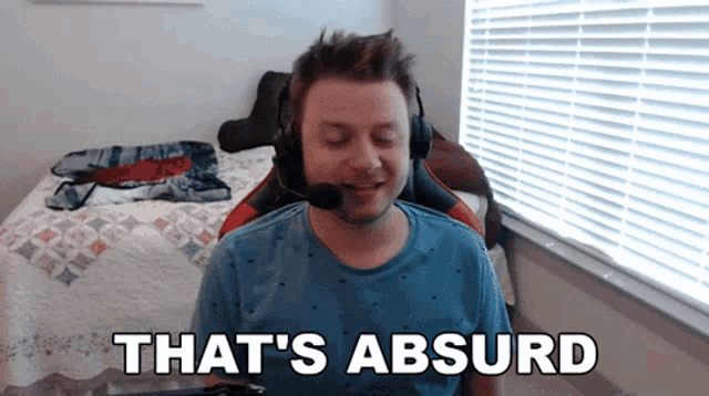 a man wearing headphones says " that 's absurd " in front of a window