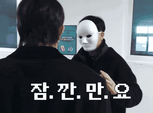 a man wearing a white mask is looking at himself