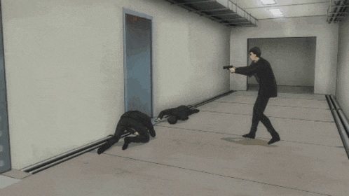 a man in a suit is pointing a gun at another man laying on the ground