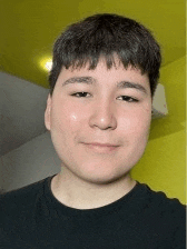 a young man wearing a black shirt is smiling for the camera .