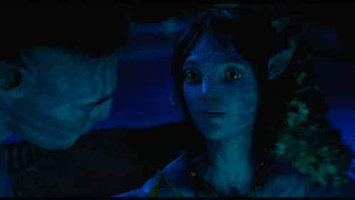 a man and a woman are looking at each other and the word mighty is on the screen