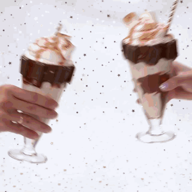 two people toasting with milkshakes with straws