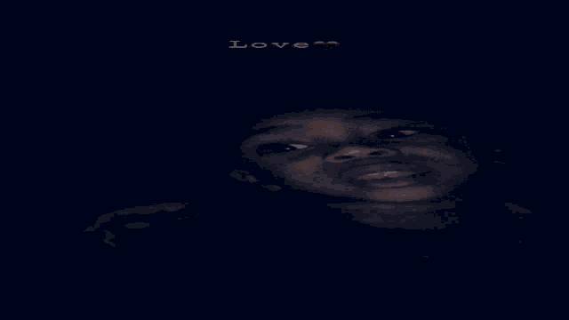 a person 's face is shown in a dark room with the words love written in the corner