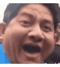 a close up of a man 's face with his mouth open and his eyes closed .