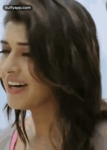 a close up of a woman 's face with a smile on her face .
