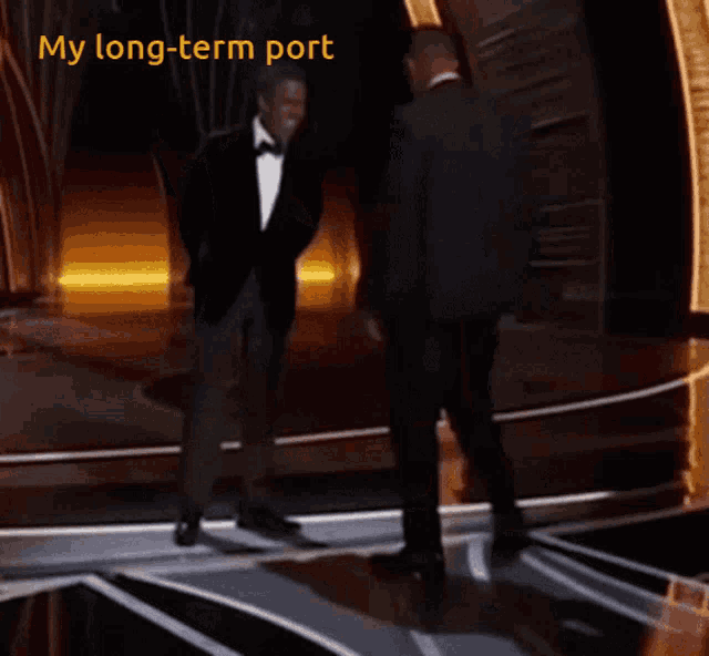 two men are dancing on a stage with the caption my long term port