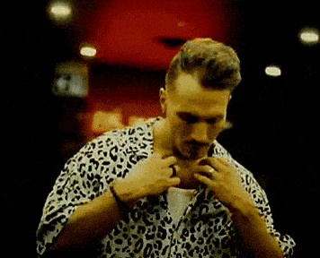 a man is wearing a leopard print shirt