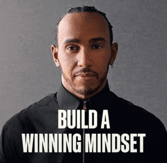 a man in a black shirt with the words build a winning mindset