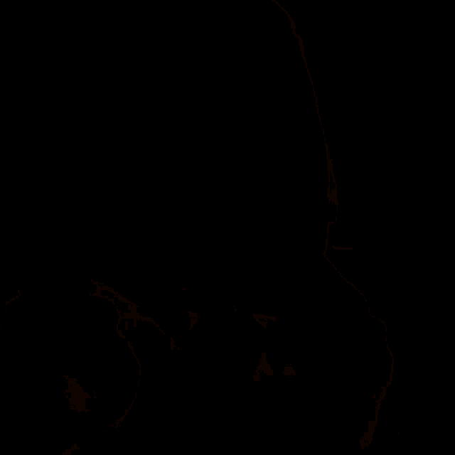 a close up of a man 's face with a light shining on his face