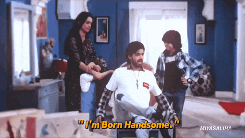 a man in a wheelchair says " i 'm born handsome " in a room with other people