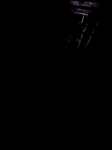 a dark room with a few lights on the walls