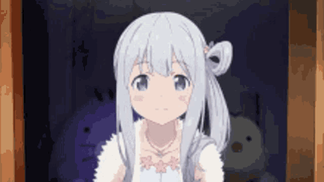 a girl with white hair and blue eyes is standing in front of a stuffed animal in a dark room .