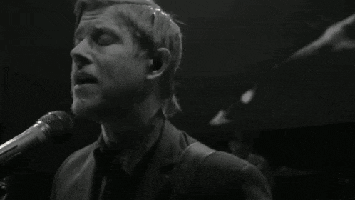 a man in a suit singing into a microphone