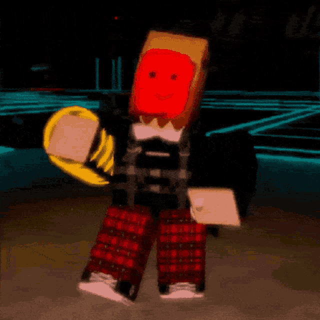 a person with a red face on their head is holding a yellow object