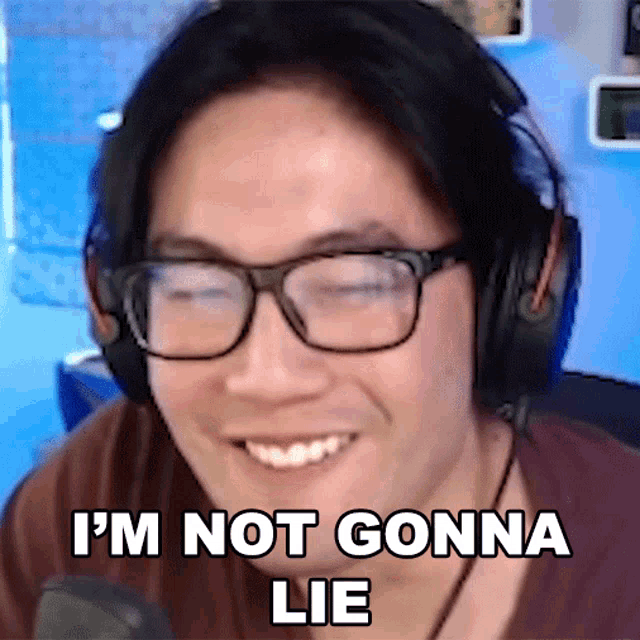 a man wearing glasses and headphones is smiling and says " i 'm not gonna lie "