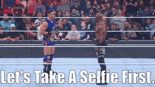 two wrestlers in a ring with the words let 's take a selfie first on the bottom
