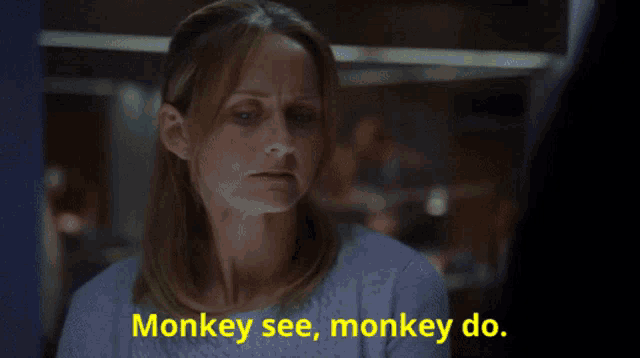 a woman says monkey see monkey do in yellow