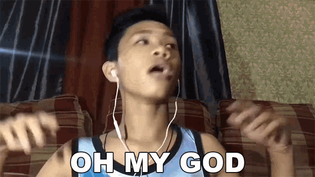 a young man wearing headphones is sitting on a couch and says oh my god