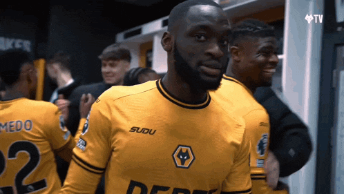 a man wearing a yellow jersey that says sudu on it