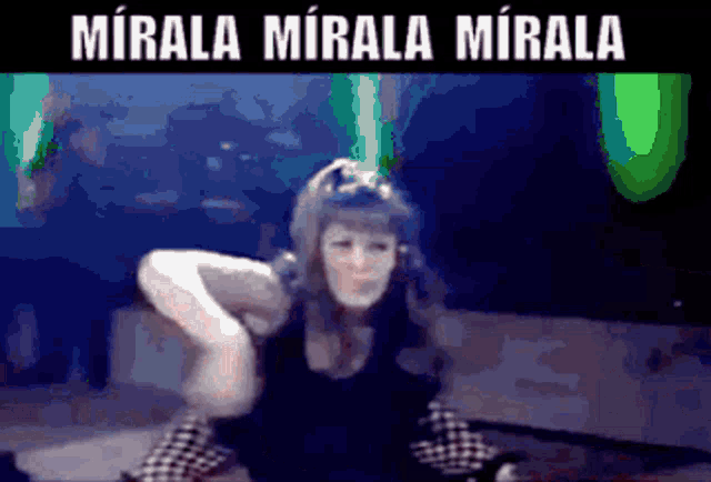 a woman is dancing with the words mirala mirala mirala written above her