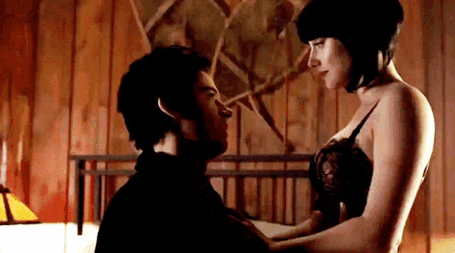 a man and a woman are looking at each other