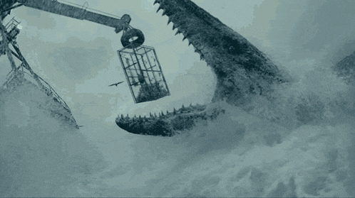 a large crocodile is eating a man in a cage in the water .