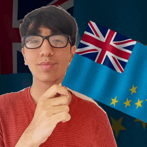 a man wearing glasses holds a flag in front of a flag