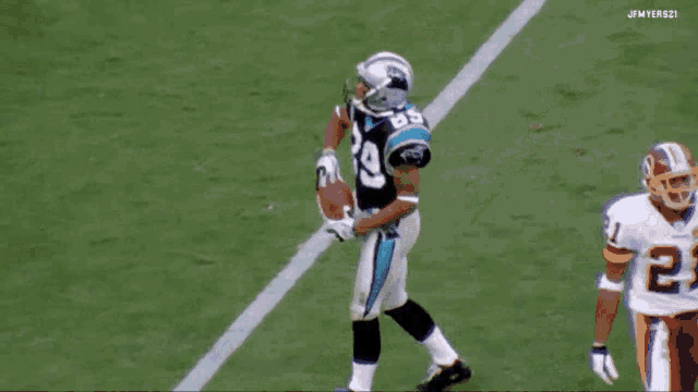 a football player wearing number 29 stands on the field