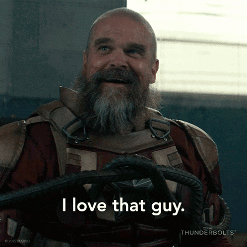 a man with a beard is holding a rope and says " i love that guy "