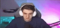 a young man wearing headphones is sitting in a chair .