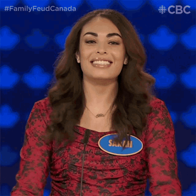 a woman in a red dress with a name tag that says sasha
